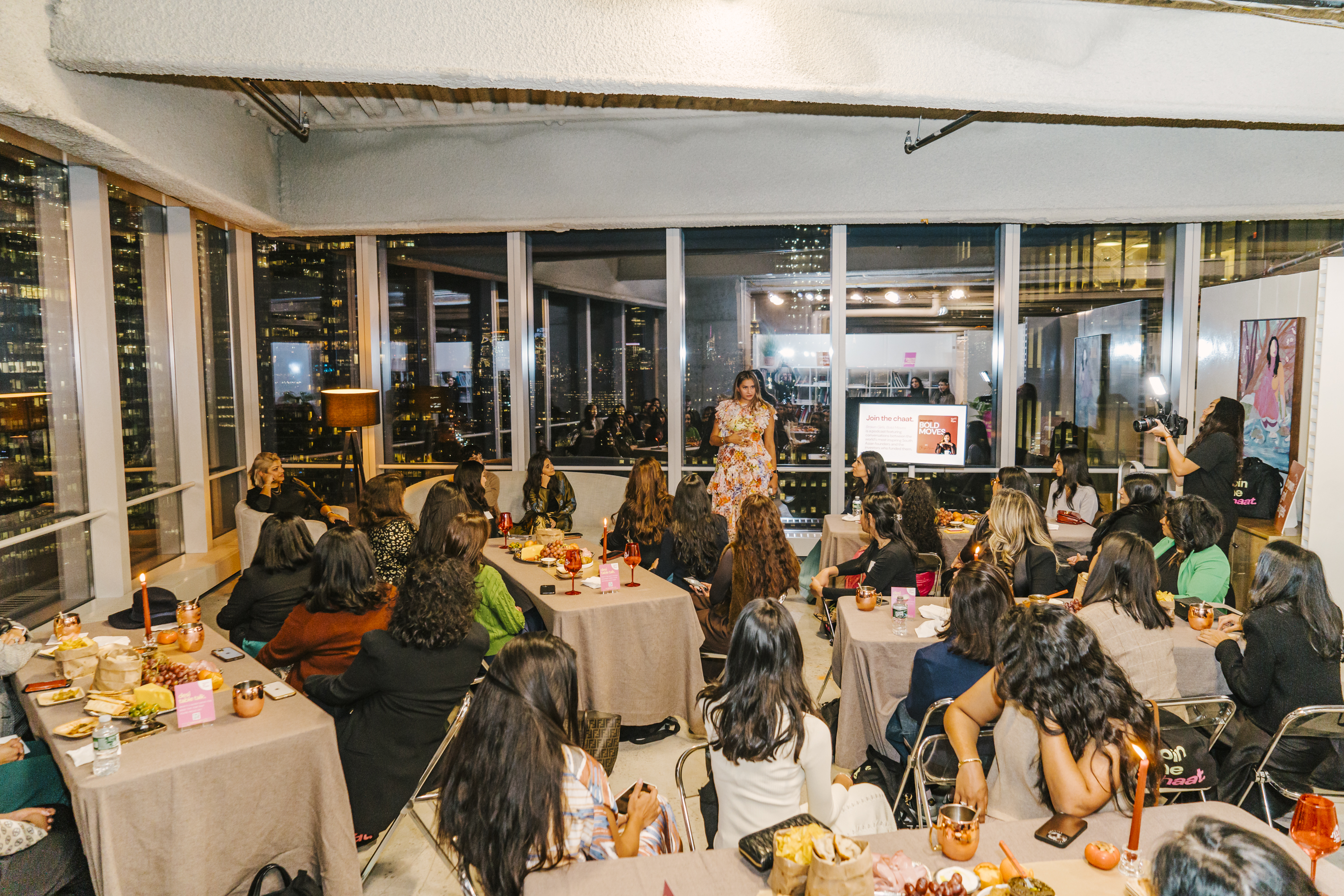 A room of senior South Asian women applauding at the Brown Girl Angels SickKids fundraiser — the didi circle, full room.