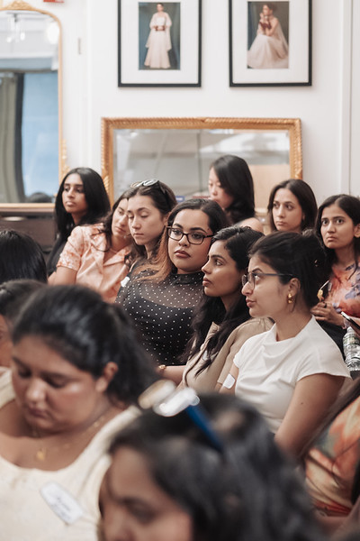 South Asian women in the audience locked in on a founder mid-pitch