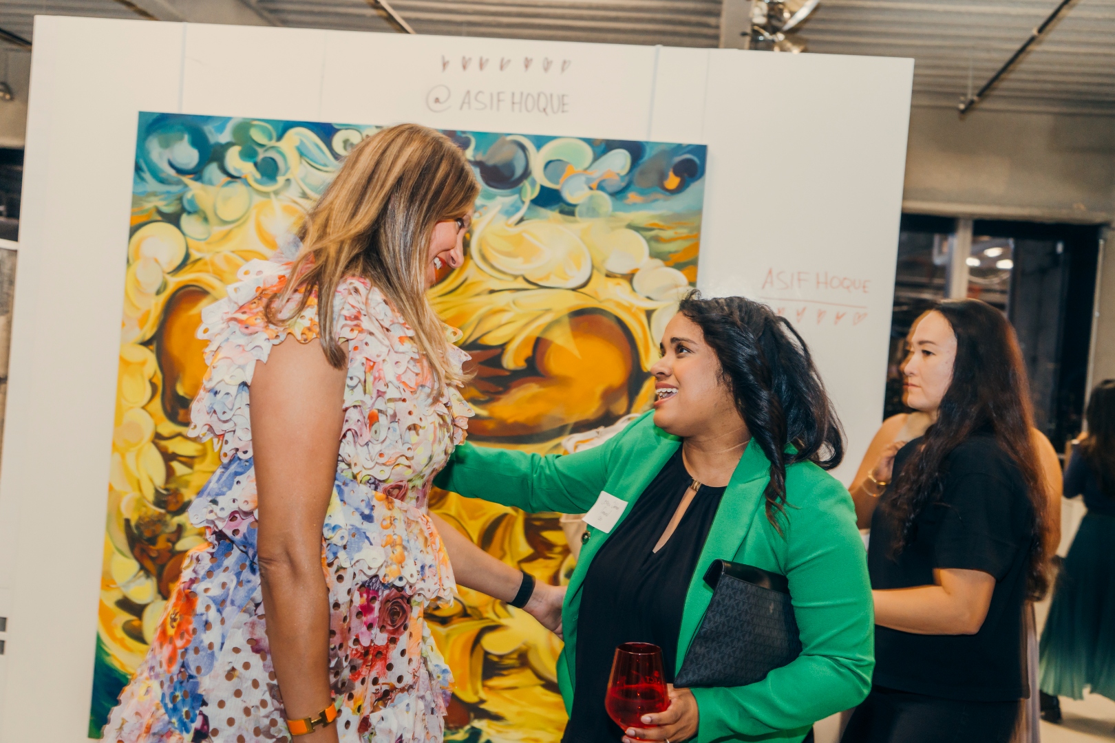 Brown Girl Angels members in conversation at Investing in Art, in front of an Asif Hoque artwork